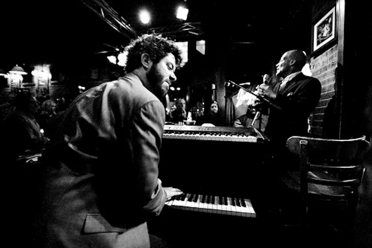 a man standing in front of a piano